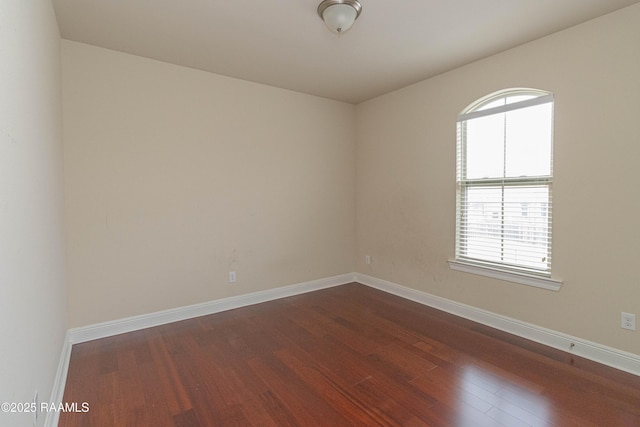 spare room featuring dark wood-type flooring