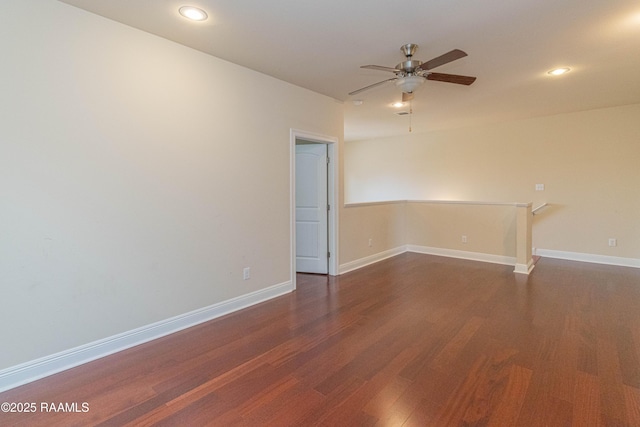 unfurnished room featuring dark hardwood / wood-style floors and ceiling fan