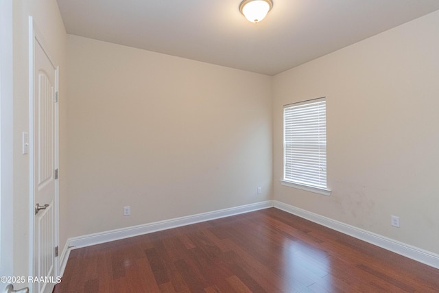 spare room featuring dark wood-type flooring