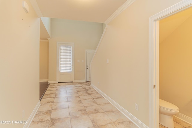 entryway with crown molding and light tile patterned flooring