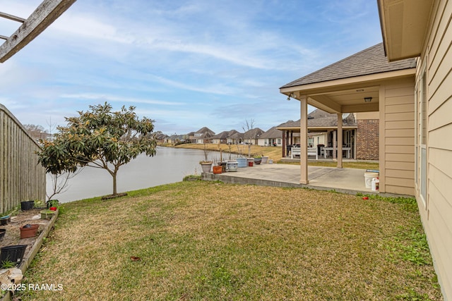 view of yard with a patio and a water view