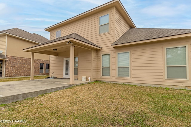 rear view of house with a yard and a patio area