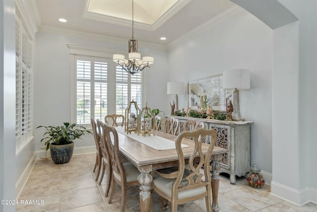 dining area featuring crown molding, light tile patterned flooring, and a chandelier