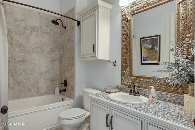 full bathroom featuring toilet, vanity, and tiled shower / bath