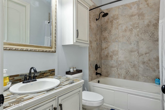 full bathroom featuring vanity, toilet, and tiled shower / bath