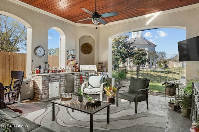 view of patio / terrace featuring ceiling fan and exterior kitchen