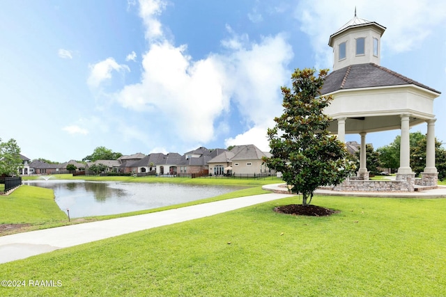 view of property's community featuring a water view and a yard