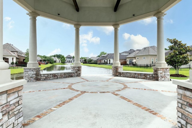 view of patio / terrace with ceiling fan and a water view