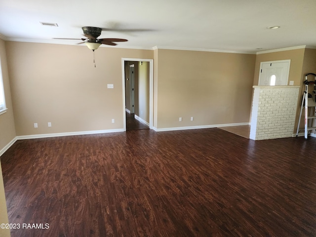 unfurnished living room with ceiling fan, crown molding, and dark wood-type flooring