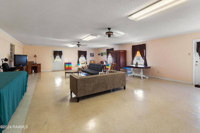 living room featuring a textured ceiling and ceiling fan