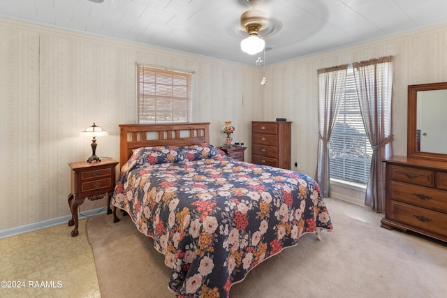 bedroom featuring ceiling fan, light colored carpet, and crown molding