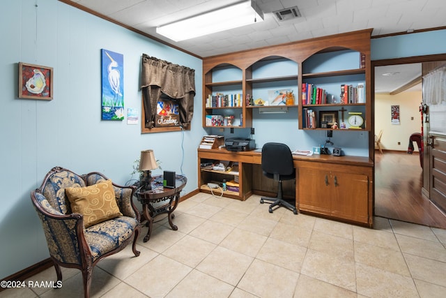 office area with light wood-type flooring and ornamental molding