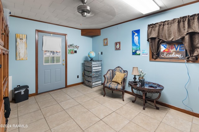 sitting room with ceiling fan, light tile patterned floors, and crown molding