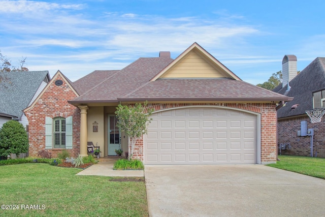 view of front of home featuring a front yard and a garage