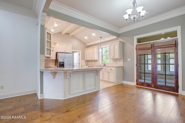 kitchen featuring stainless steel fridge with ice dispenser, light wood-type flooring, and white cabinetry