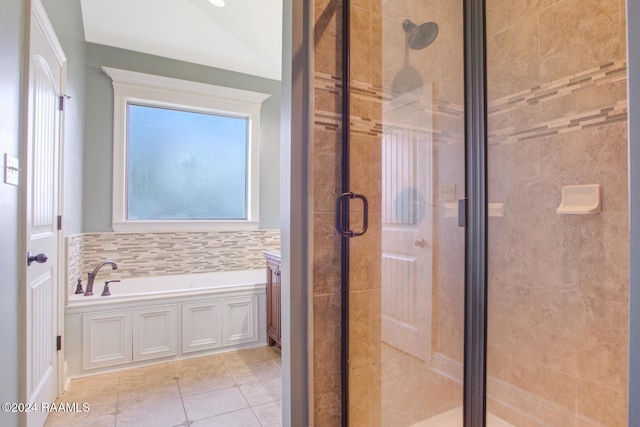 bathroom featuring tile patterned flooring and independent shower and bath