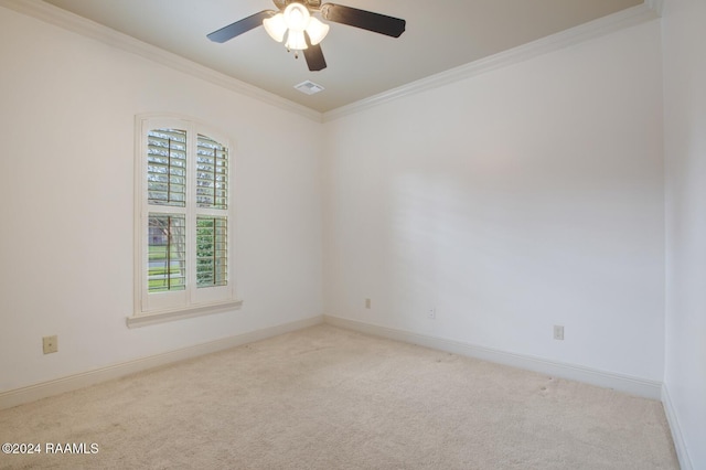 empty room with ceiling fan, ornamental molding, and light carpet