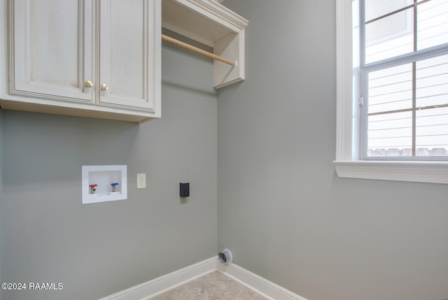 laundry room with washer hookup, electric dryer hookup, and cabinets