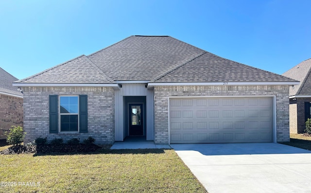 view of front of home featuring brick siding, a shingled roof, concrete driveway, an attached garage, and a front lawn