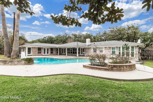 back of house with a lawn, french doors, and a patio