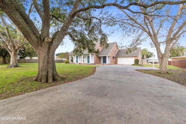 view of front of house with a front yard and a garage