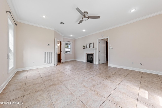 unfurnished living room with ceiling fan, ornamental molding, and light tile patterned floors