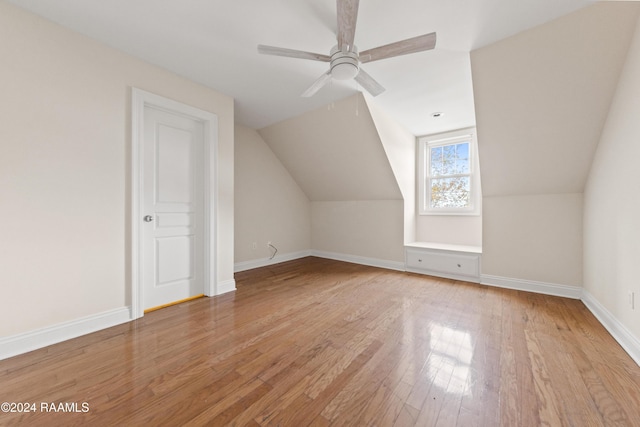 additional living space featuring ceiling fan, lofted ceiling, and light wood-type flooring