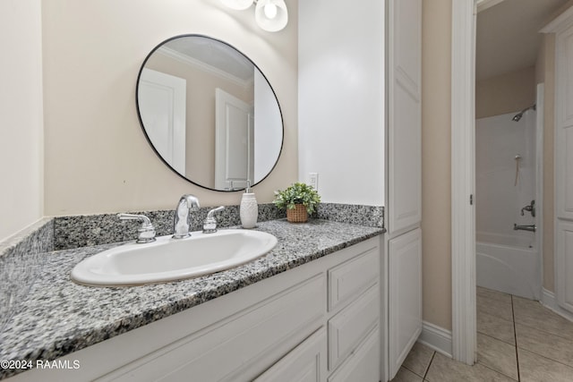 bathroom featuring tile patterned floors, vanity, crown molding, and bathing tub / shower combination