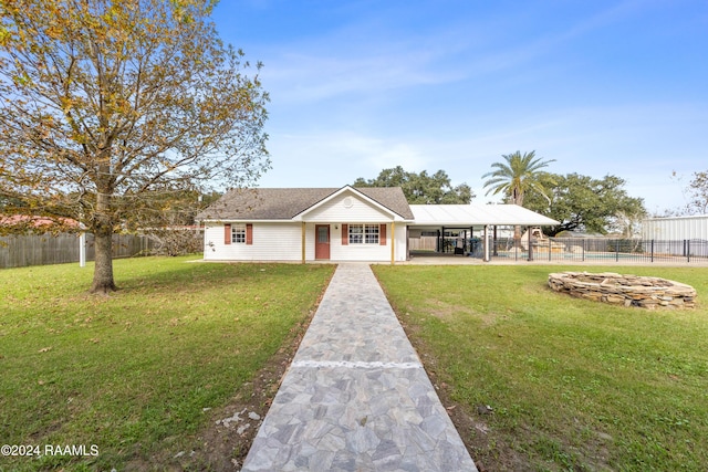 view of front of property with a front yard and a carport