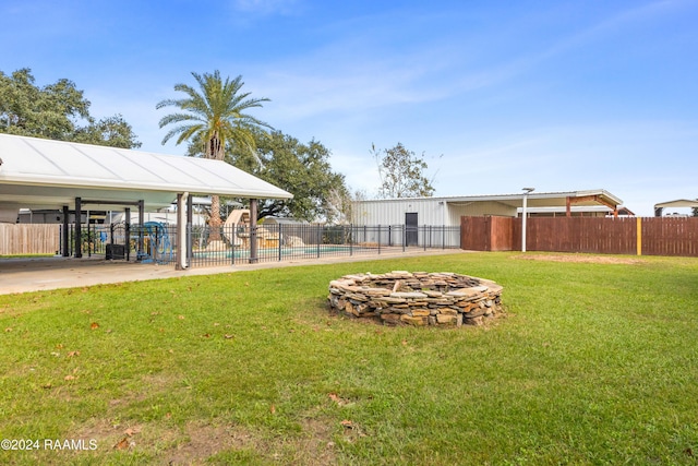 view of yard with a fire pit and a pool