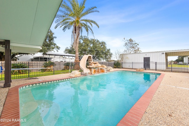 view of swimming pool with a water slide