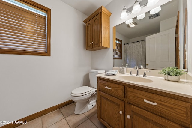 bathroom with tile patterned flooring, vanity, curtained shower, and toilet