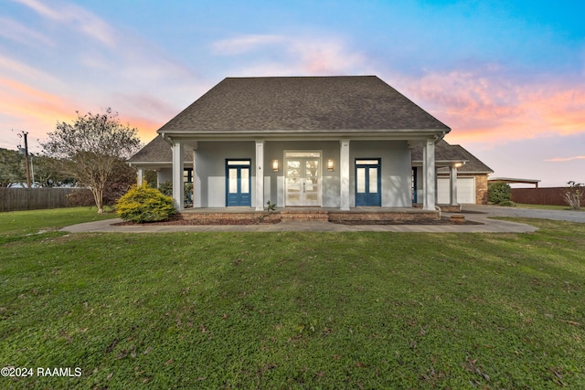 view of front of property featuring a yard and french doors