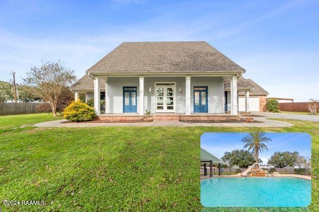 back of property featuring a lawn and french doors