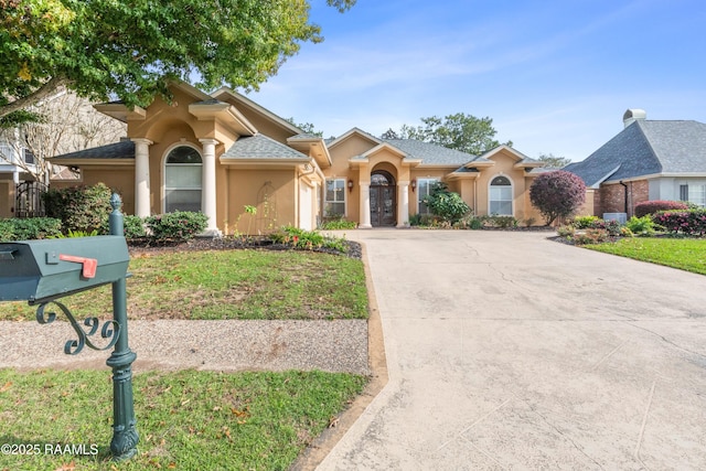 view of front of property featuring a shingled roof, concrete driveway, an attached garage, and stucco siding