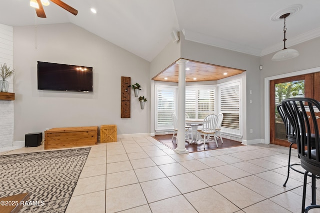 dining space featuring lofted ceiling, light tile patterned floors, plenty of natural light, and ornate columns