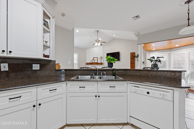 kitchen with white cabinetry, sink, white dishwasher, and kitchen peninsula