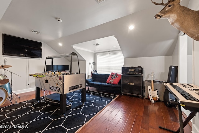 game room with wood-type flooring and vaulted ceiling