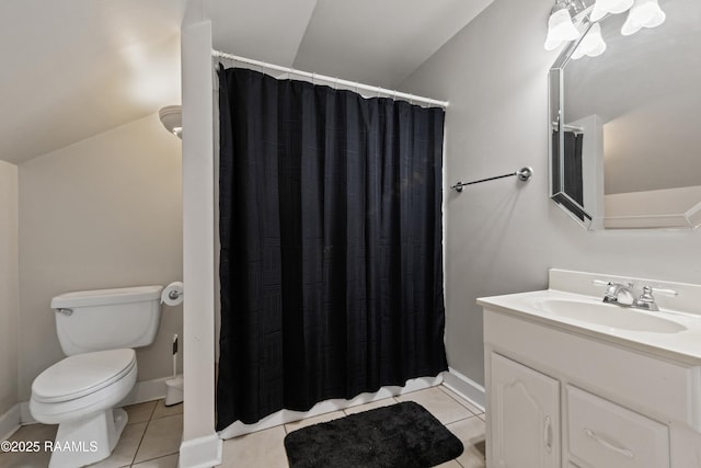 bathroom featuring tile patterned floors, lofted ceiling, toilet, and vanity