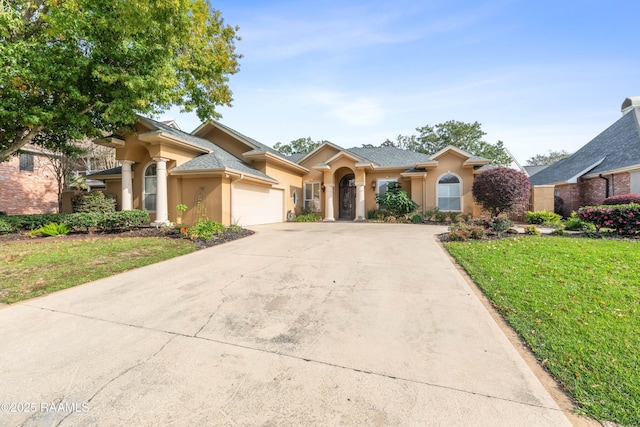 view of front of house with a garage and a front lawn