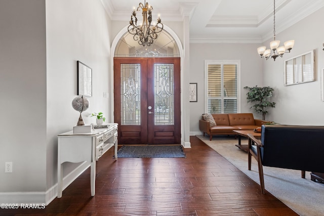 entrance foyer featuring baseboards, dark wood-style flooring, french doors, crown molding, and a notable chandelier