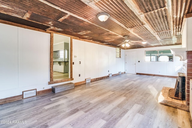 unfurnished living room featuring ceiling fan, light hardwood / wood-style floors, and wood ceiling