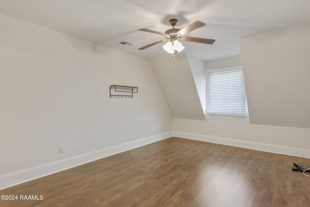 spare room with dark hardwood / wood-style floors, ceiling fan, and vaulted ceiling