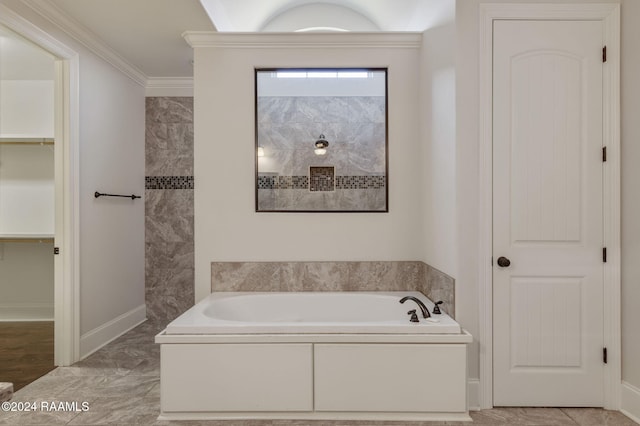 bathroom with a washtub and crown molding