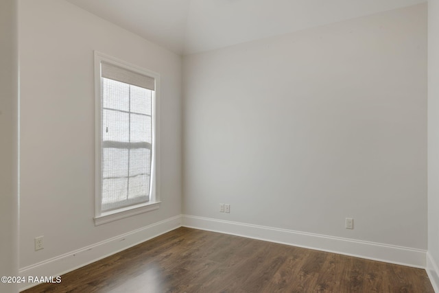 empty room featuring dark hardwood / wood-style floors and a healthy amount of sunlight