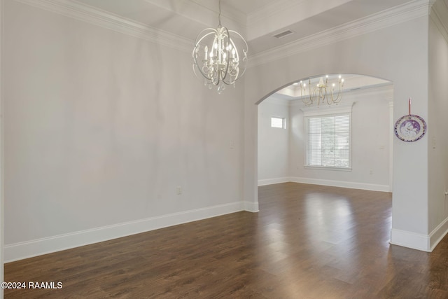 empty room featuring dark hardwood / wood-style floors, ornamental molding, and a chandelier