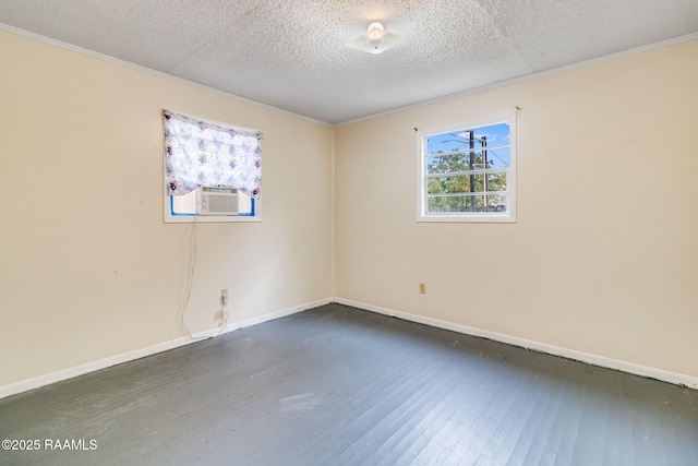 empty room with a textured ceiling, ornamental molding, and dark wood-type flooring