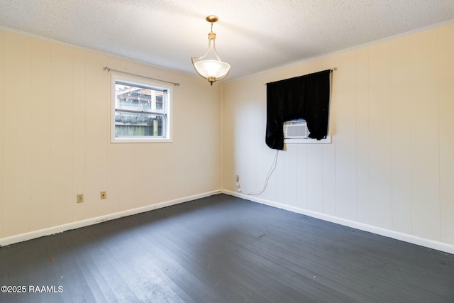 unfurnished room with crown molding, dark wood-type flooring, and a textured ceiling