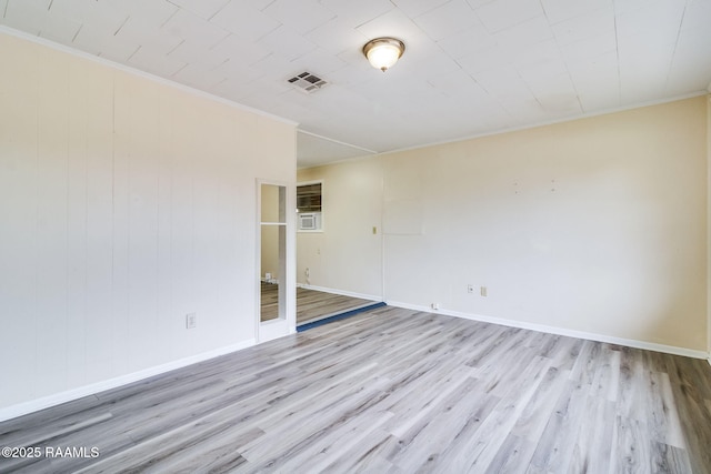 unfurnished room featuring light hardwood / wood-style flooring and crown molding