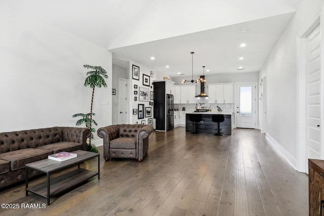 living room featuring lofted ceiling and wood-type flooring